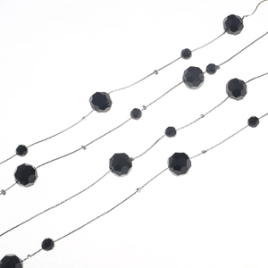 Detail of faceted black beads and silver metal chain link for a dual-use sweater necklace