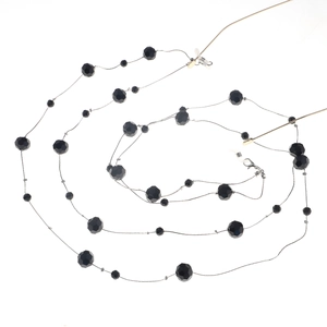 Detail of black faceted crystal beads on double-layer eyewear chain with silicone loops