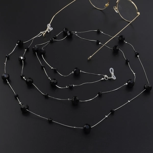 Detail of beaded glasses chain with black faceted beads and adjustable silicone loops