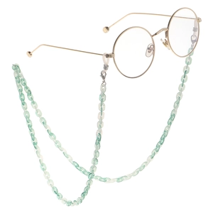 Round gold metal glasses with a light green acrylic resin chain on white background