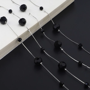 Detail of silver chain with faceted black crystal beads for glasses and sweaters