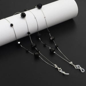 Macro view of black faceted crystal beads and silver chain with silicone eyeglass loops