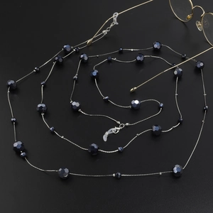 Detail of dark blue crystal beads and silver chain with silicone eyeglass loops