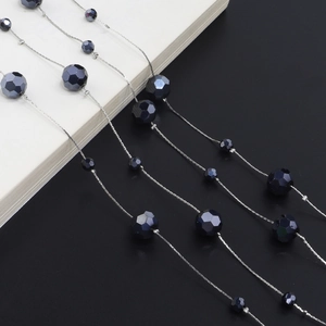 Detail of faceted black crystal beads on a silver dual-use sweater and glasses chain