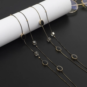 Gouden slangenketting voor brillen en truien met zwarte ovale kralen en kristallen kralen