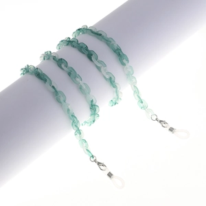 Detail of green acrylic glasses chain with silver lobster clasps and silicone loops