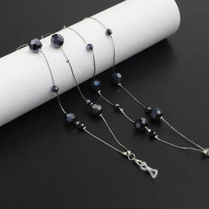 Detail of dark blue crystal beads on a versatile silver chain for glasses and sweaters
