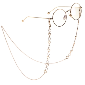 Lunettes rondes rétro dorées avec chaîne à maillons en forme de cœur sur fond blanc