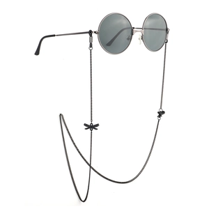 Retro round sunglasses with black butterfly pendant eyewear chain on white background