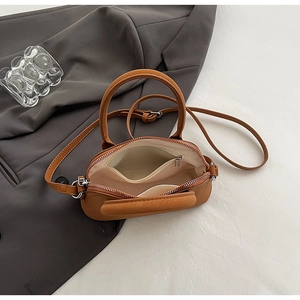 Overhead view showing the spacious interior and silver zipper of this brown shell bag
