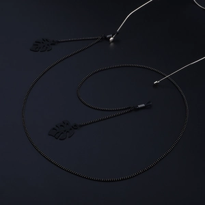 Minimalist black metal eyewear chain featuring hollow leaf pendants and secure rubber loops