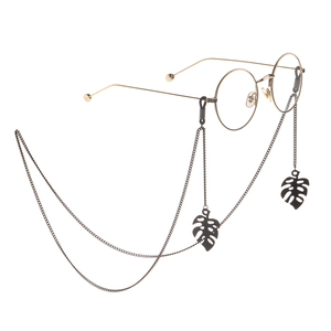 Gold round glasses with long black monstera leaf pendant eyewear chain and metal links