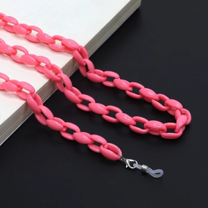 Close-up of bright pink acrylic chain link strap with silver clasps and silicone loops