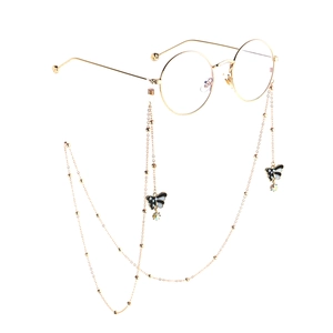 Golden round glasses with elegant butterfly and pearl charm eyewear chain accessory