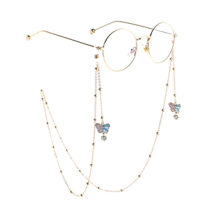 Golden round frame glasses with elegant purple butterfly pearl chain on white background