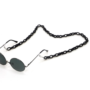 Detail shot of chunky black acrylic eyeglass chain with vintage round sunglasses