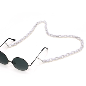 Detail showing chunky white acrylic link chain attached to black round sunglasses frame