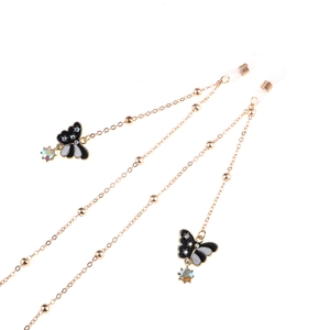 Detail of gold eyewear chain with enamel butterflies, rhinestones and crystal charms