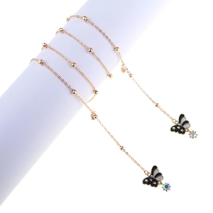 Detail of gold eyewear chain with pearls, crystal butterfly pendants and iridescent beads