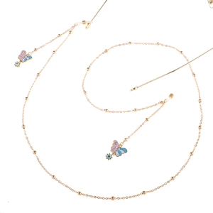 Detail of golden glasses chain featuring colorful enamel butterflies and small gold beads