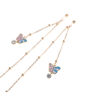 Golden eyewear chain with enamel butterfly charms and sparkling gemstones on white background
