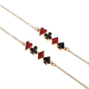 Golden eyewear chain with colorful poker suit charms including heart, spade, club, and diamond