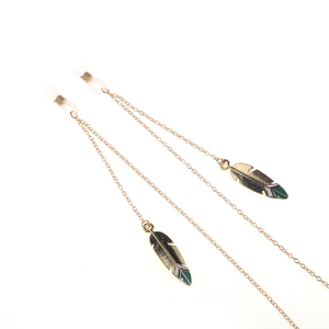 Golden eyewear chain featuring leaf pendants and non-slip silicone loops on white background