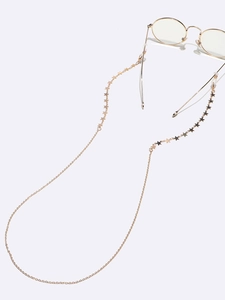 Detail of star-shaped golden glasses chain showing hook attachment on white background