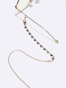 Detail of golden glasses chain with star charms and clear silicone anti-slip connectors