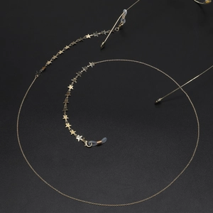 Golden star charms eyewear chain with non-slip silicone loops for sunglasses on black surface