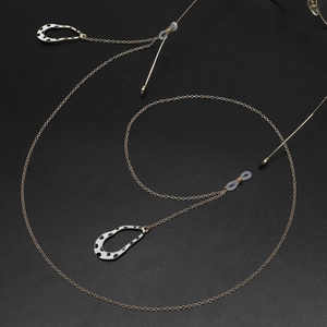 Golden eyewear chain with leopard print pendants and anti-slip rings on black background