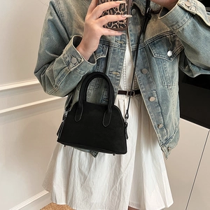 Minimalist black matte shell bag for women with top handle and crossbody strap