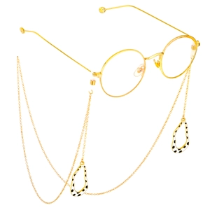Golden round glasses with stylish polka dot pendant lanyard on a white background