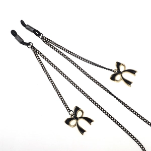 Fashionable black and gold eyewear chain with elegant bow charms and non-slip rubber loops