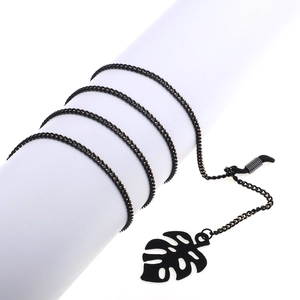 Fashionable black metal eyewear chain featuring a minimalist hollow leaf pendant design