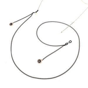 Elegant black metal eyewear chain featuring crown pendants and pearl accents on white background