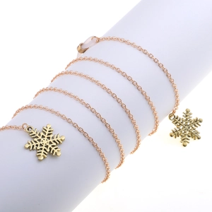 Detail of golden metal eyewear chain featuring hollow snowflake pendants and anti-slip loops