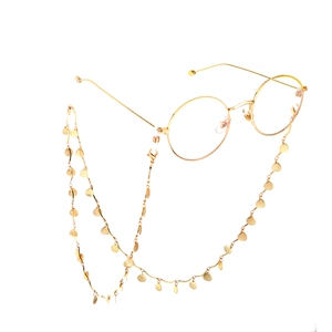 Chaîne de lunettes dorée avec breloques feuilles et coquillages sur monture ronde