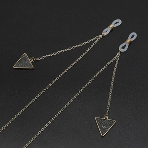 Golden metal eyewear chain with black matte triangle pendants and anti-slip silicone rings