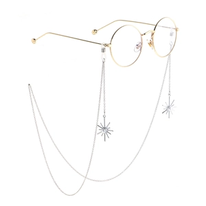 Golden round glasses with snowflake pendants and pearl beads on a metallic eyewear chain