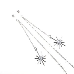 Macro detail of silver eyeglass chain with snowflake pendants and pearl accents