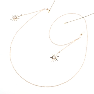 Detail of gold eyewear chain with snowflake pearl charms and silicone anti-slip loops