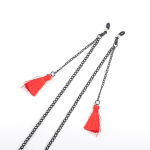 Black metal eyewear chain with vibrant red tassels and rubber loops on white background