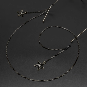 Black and gold eyewear chain with enamel stars and sparkling rhinestone pendants