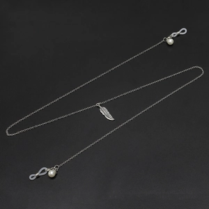 Silver eyewear chain with feather pendant and pearls for glasses on black background