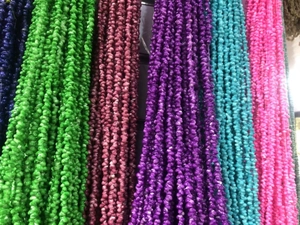 Detail of colorful seashell spectacle chains in green, red, purple, and blue hues