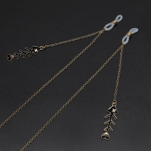 Golden non-slip eyeglass chain featuring black enamel fishbone charms and silicone loops