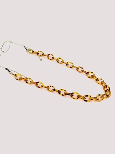 Detailed view of tortoise shell acrylic eyeglass chain with black silicone connectors