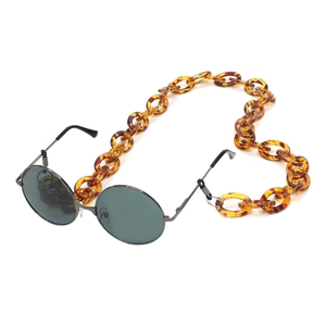 Retro round metal sunglasses with amber acrylic eyewear chain on white background