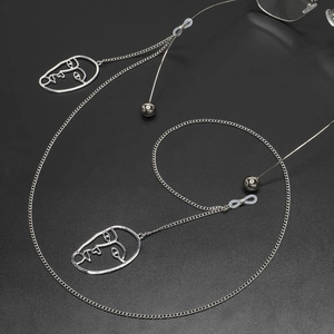 Silver metal glasses chain with abstract hollow face pendants and non-slip loops